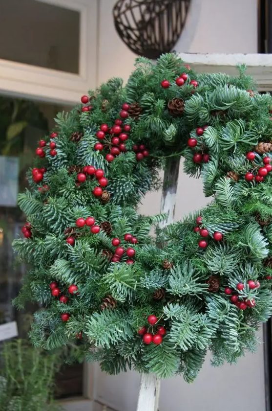 a fab Christmas wreath of evergreens, pinecones and cranberries is a very beautiful and cool front door decoration