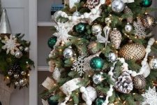 a fabulous Christmas tree with silver and metallic ornaments, bold green ones, bead garlands, snowy pinecones and snowflakes