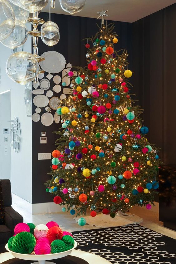 a floating Christmas tree with lights and colorful paper ornaments is a cool and catchy decor idea with plenty of color