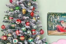 a flocked Christmas tree decorated with colorful vintage Christmas ornaments placed into a drum is a creative idea