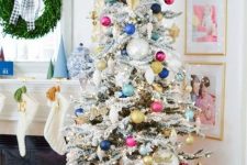 a flocked Christmas tree with colorful ornaments and lights plus a star topper for a fun touch