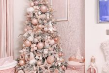 a glam flocked Christmas tree with blush and silver ornaments, ribbons and stars plus frozen branches on top