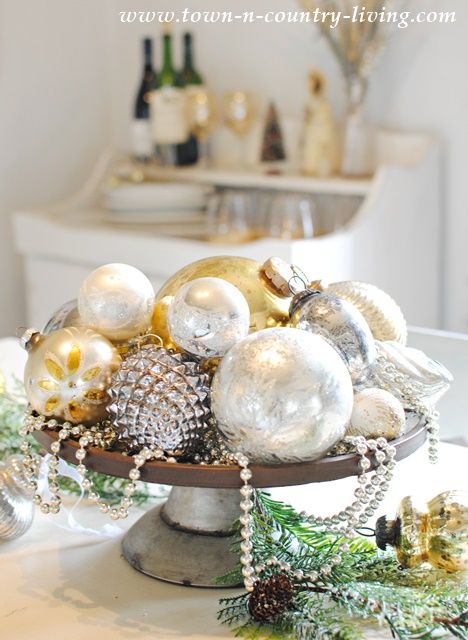 a glam vintage Christmas centerpiece with silver and gold ornaments and beds is a lovely and chic idea