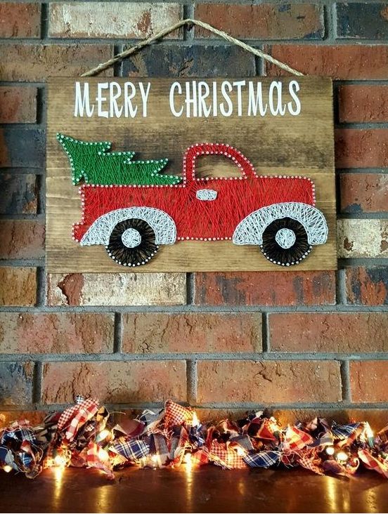 A gorgeous red lorry with a Christmas tree string art for a funny touch, it looks bright and very holiday inspired