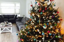 a large Christmas tree decorated with lights, beads and super colorful ornaments is amazing