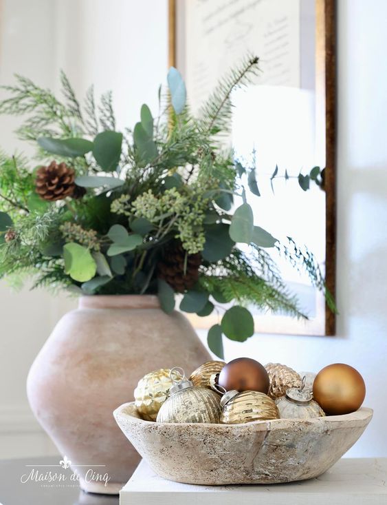 a lovely Christmas arrangement of a whitewashed bowl with gold and brown ornaments is a cool idea