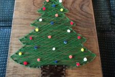 a lovely Christmas tree string art done with colorful pompoms as ornaments is a cool solution for the holidays