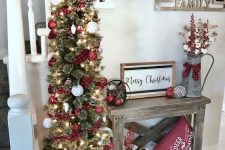 a lovely pencil Christmas tree with red plaid ribbons, white and red ornaments and lights is a stylish traditional decor idea