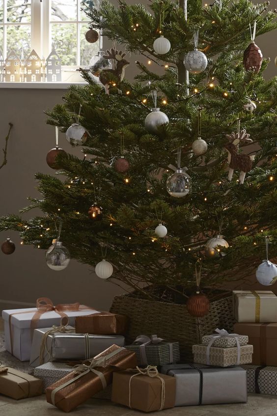 a modern Christmas tree with lights, silver, white and brown ornaments is a cool and catchy decor idea
