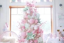 a cute christmas tree decorated with pink ornaments
