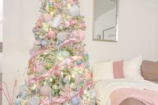 a pastel candy Christmas tree decorated with pastel blue and pink ornaments, candies, candy canes and gingerbread men is amazing