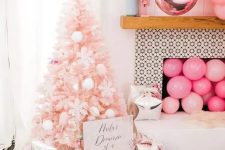 a pastel pink Christmas tree decorated with white pompoms, ice cream cones, snowflakes is a dreamy and pretty idea for a glam space