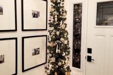 a pencil Christmas tree with lights and whimsical neutral ornaments plus a star topper is great for an entryway