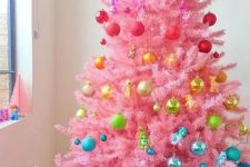 a bold pink christmas tree with colorful touches