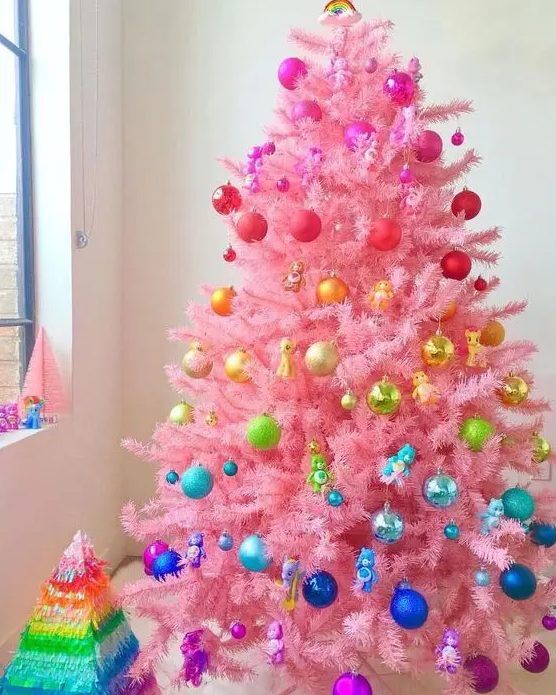 a pink Christmas tree styled like a rainbow is a fun and cool idea for a bright holiday space