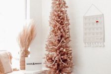 a pink pencil Christmas trees with lights and white beads will be a lovely solution for a boho space