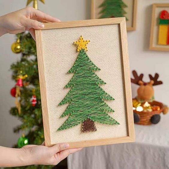 a pretty and easy Christmas tree string art piece in a frame is a cool and catchy decoration for the holidays