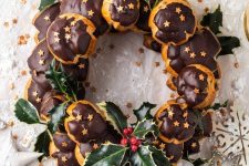 a profitrole wreath with chocolate and mistletoe is a fantastic alternative to a usual Christmas cake