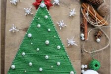a refined bold Christmas tree decorated with pearls and a bow plus string art stars around