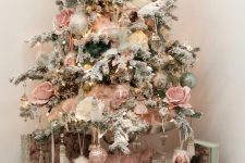 a refined vintage Christmas tree with lights, pink roses and silver, pink and green ornaments and fluffy pink garlands