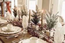 a rustic Christmas tablescape with woven placemats, white porcelain and mugs, berries and mini Christmas trees