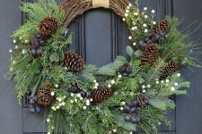 a rustic Christmas wreath of vine, evergreens, foliage, berries and pinecones is a gorgeous decoration for the holidays