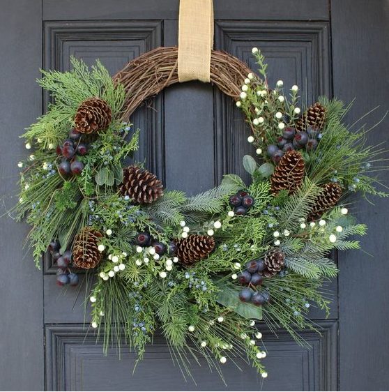 a rustic Christmas wreath of vine, evergreens, foliage, berries and pinecones is a gorgeous decoration for the holidays