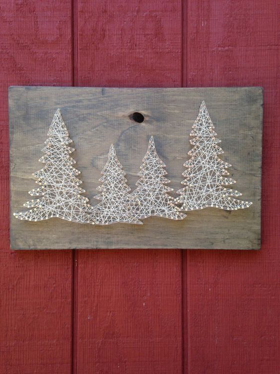 a shabby chic wooden plaque with white strign art Christmas trees is a lovely and cool decor idea