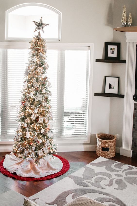 a shiny pencil Christmas tree decorated with a burlap banner, lights and various whimsical ornaments is a cool idea