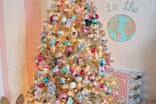 a silver Christmas tree with lights and colorful ornaments is a catchy and cool decor idea
