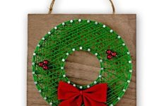 a simple and cute holiday string art piece showing a green wreath with red ornaments and a red bow is a cool favor