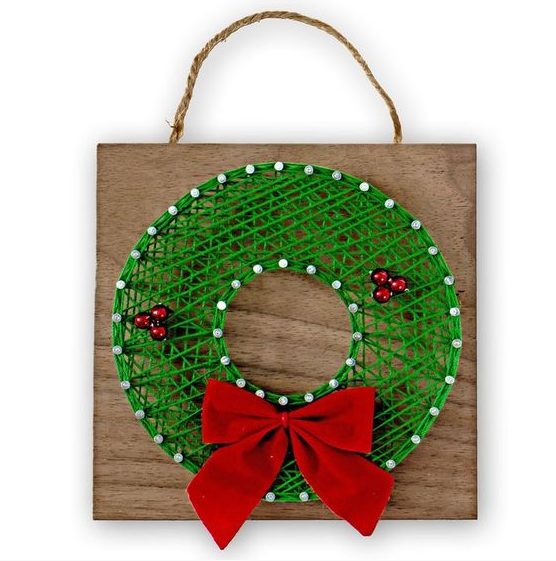 a simple and cute holiday string art piece showing a green wreath with red ornaments and a red bow is a cool favor