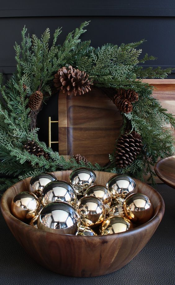 A simple timber bowl with shiny gold ornaments is a simple last minute decoration to rock for the holidays