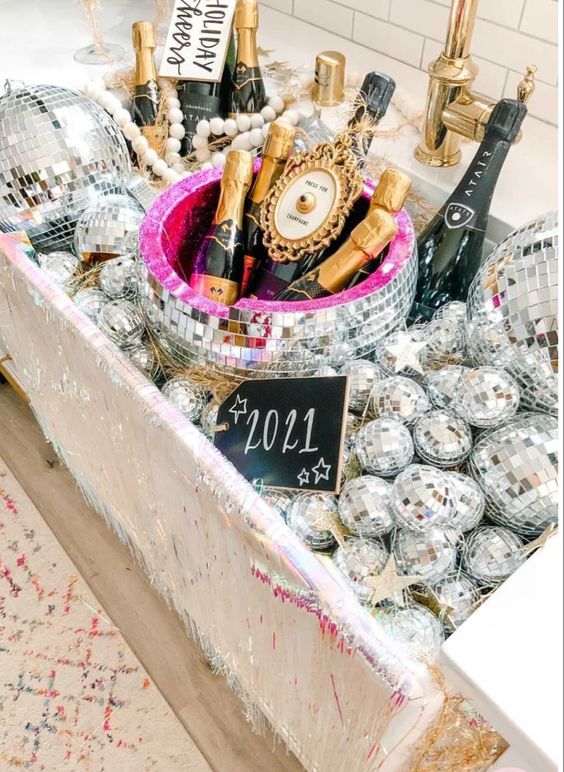 a sink filled with disco balls and champagne bottles is a gorgeous idea for celebrating NYE