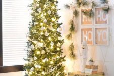 a skinny Christmas tree with white and himmeli ornaments and lights is a cool and catchy decor idea