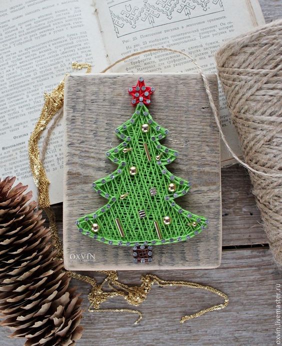 a small Christmas string art piece done with green string and gold beads is a cool decoration or an ornament