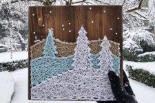 a snowy winter string art in beige, light blue and white, with ornaments, is a lovely Christmas party decoration