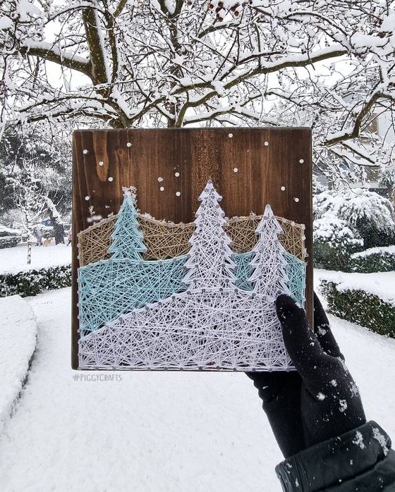 a snowy winter string art in beige, light blue and white, with ornaments, is a lovely Christmas party decoration