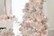 a sophisticated white Christmas tree decorated with neutral and blush oversized ornaments, branches and lights