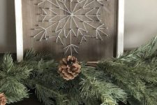 a subtle Christmas string art showing a snowflake done with neutral string is a very cool idea for a rustic space