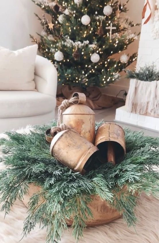 a vintage Christmas centerpiece of a wooden bowl, evergreens and vintage bells is a lovely arrangement
