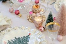 a vintage Christmas tea party table done in candy colors, with ornaments and gold-rimmed glasses