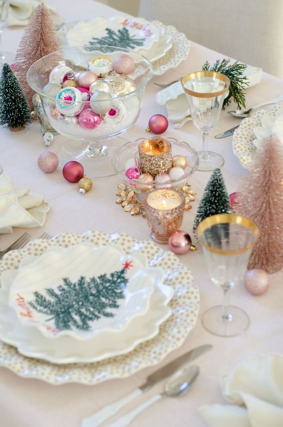 a vintage Christmas tea party table done in candy colors, with ornaments and gold-rimmed glasses