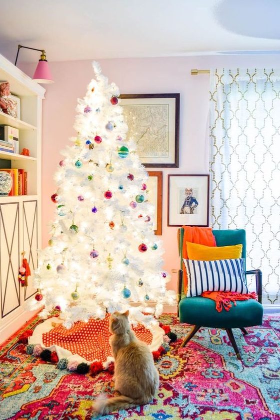 a white Christmas tree with super colorful ornaments looks contrasting and bold