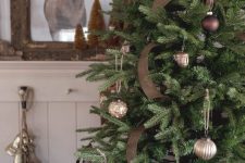 a woodland Christmas tree with brown burlap ribbon, silver and brown ornaments is a stylish decoration