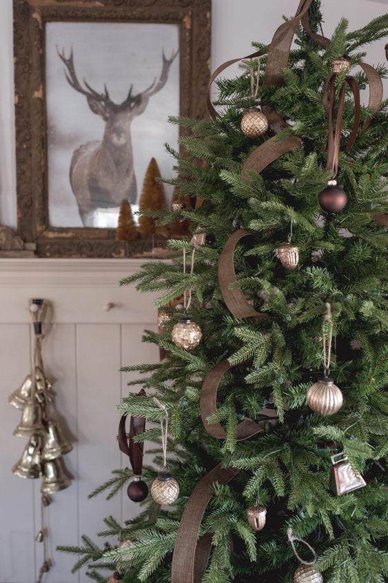 a woodland Christmas tree with brown burlap ribbon, silver and brown ornaments is a stylish decoration
