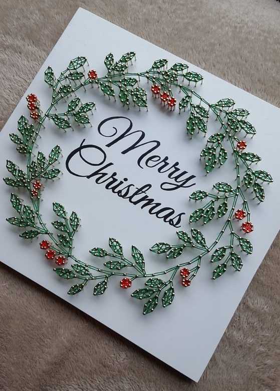 an elegant Christmas string art piece with calligraphy and strign art leaves and berries is wow
