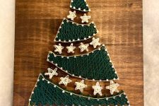 an eye-catchy Christmas tree string art with star garlands and a star topper is a lovely decoration