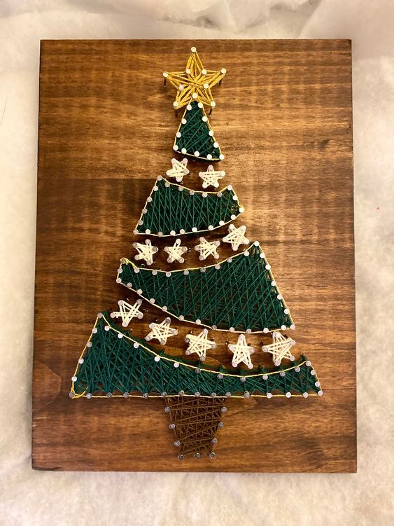 An eye catchy Christmas tree string art with star garlands and a star topper is a lovely decoration