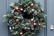 beautiful copper and brown baubles, frosted pine cones and miniature copper bells for the wreath